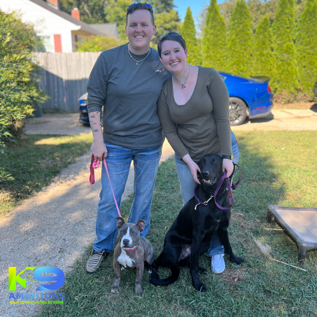 Trainers with two dog graduates